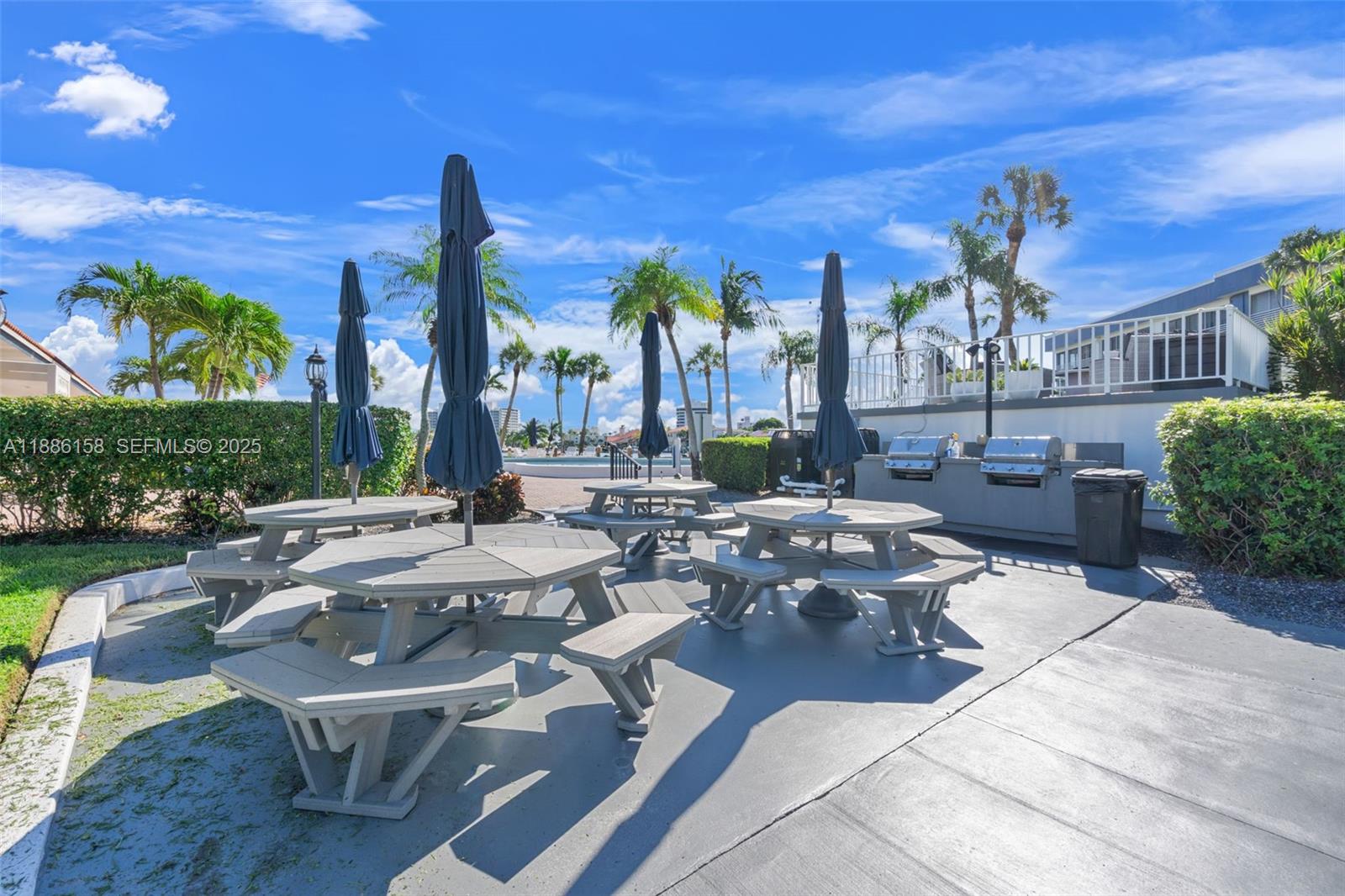3301 Spanish Trail, Unit 207 Delray Beach, FL 33483 - Photo 28 of 38 a view of a patio with couches table and chairs