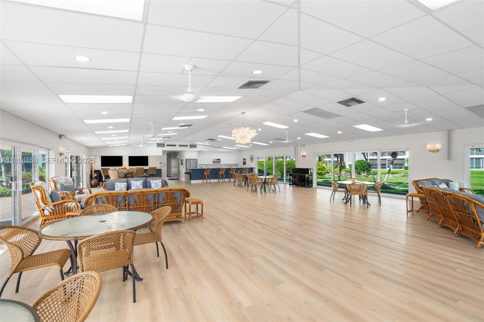 3301 Spanish Trail, Unit 207 Delray Beach, FL 33483 - Photo 29 of 38 a living room with furniture wooden floor and a kitchen view