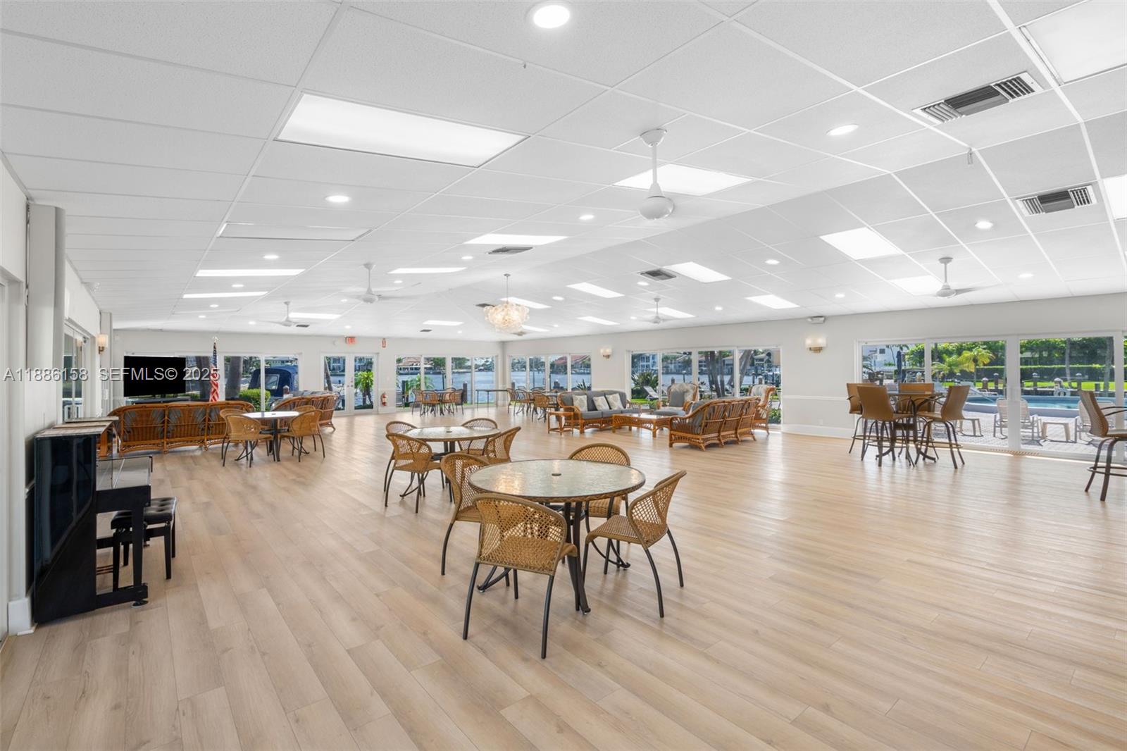 3301 Spanish Trail, Unit 207 Delray Beach, FL 33483 - Photo 30 of 38 a dining room with stainless steel appliances lots of furniture and wooden floors