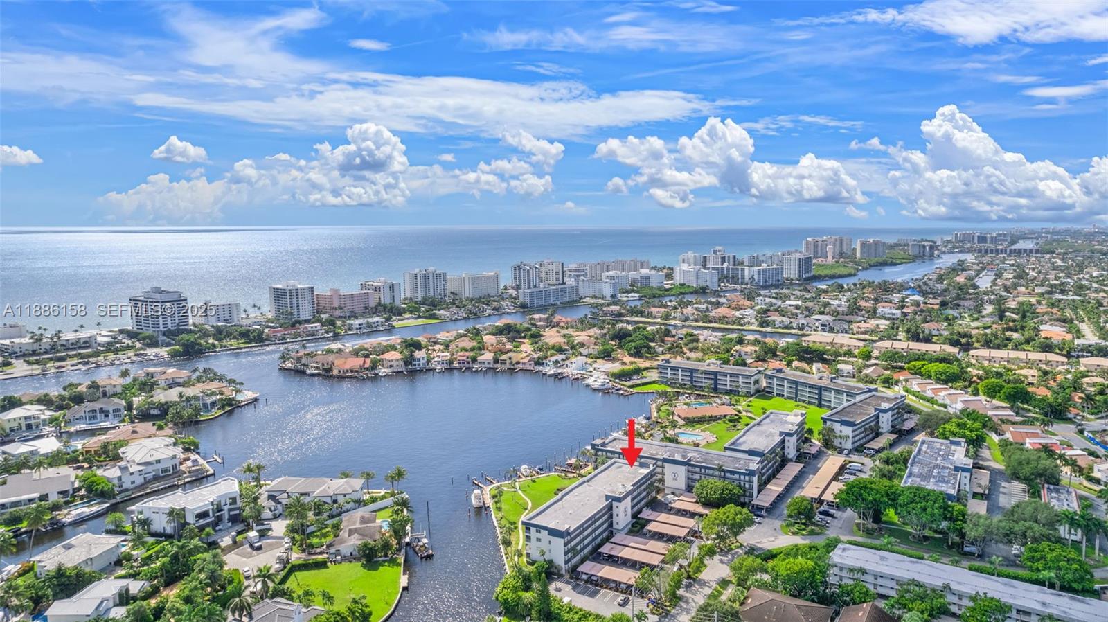 3301 Spanish Trail, Unit 207 Delray Beach, FL 33483 - Photo 32 of 38 an aerial view of a city with lots of residential buildings ocean and mountain view in back