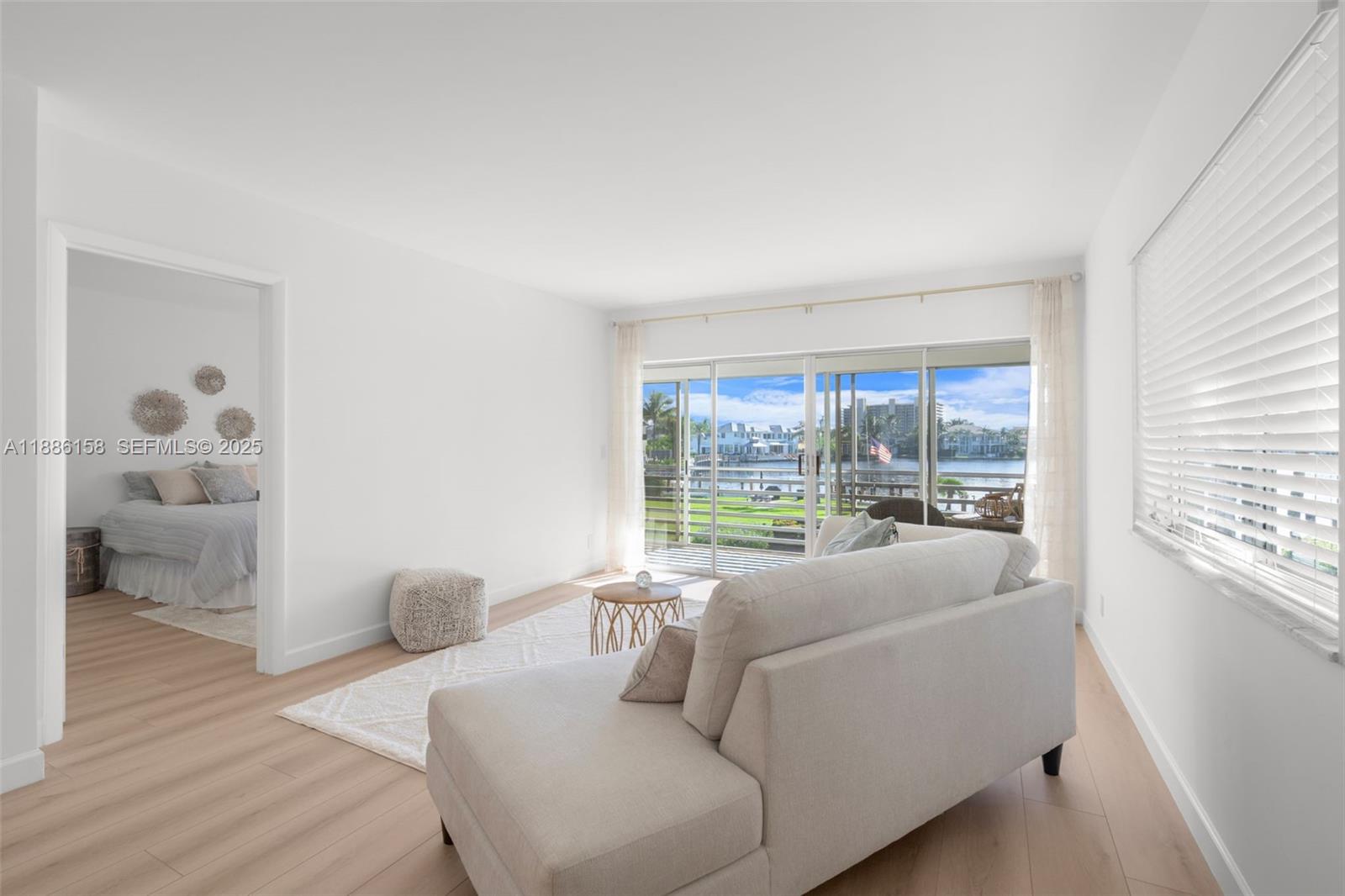 3301 Spanish Trail, Unit 207 Delray Beach, FL 33483 - Photo 6 of 38 a living room with furniture and a large window