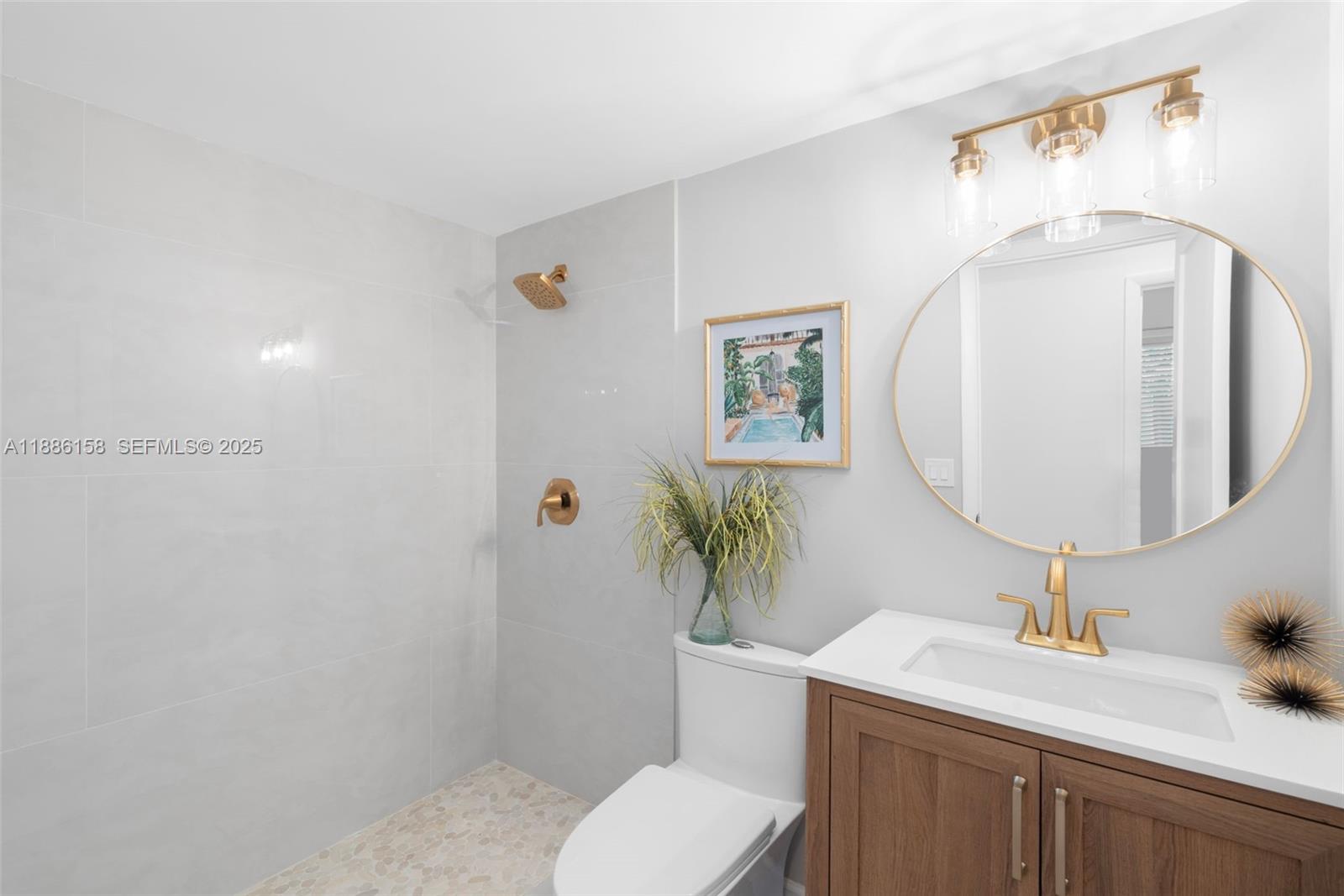 3301 Spanish Trail, Unit 207 Delray Beach, FL 33483 - Photo 8 of 38 a bathroom with a sink toilet and mirror