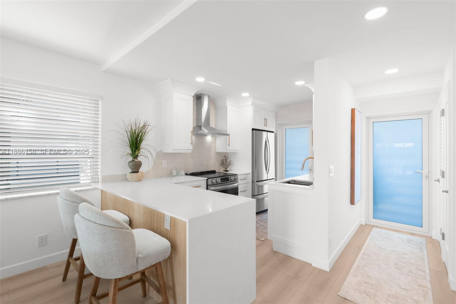 3301 Spanish Trail, Unit 207 Delray Beach, FL 33483 - Photo 9 of 38 a kitchen with a table and chairs in it