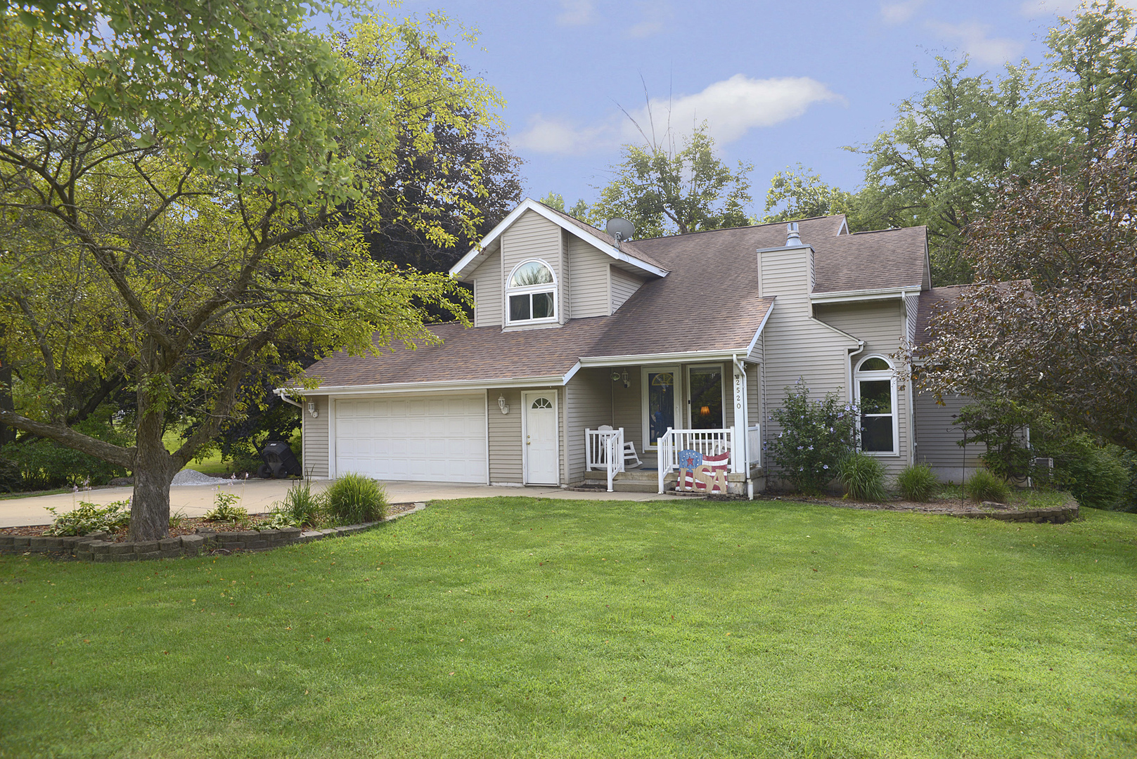 2520 Champlain Street Ottawa, IL 61350 - Photo 1 of 1 a front view of a house with a garden and trees