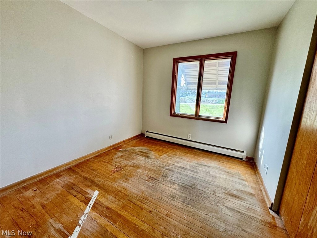 1445 Killian Road Akron, OH 44312 - Photo 9 of 21 Bedroom with baseboard heating and light hardwood / wood-style flooring