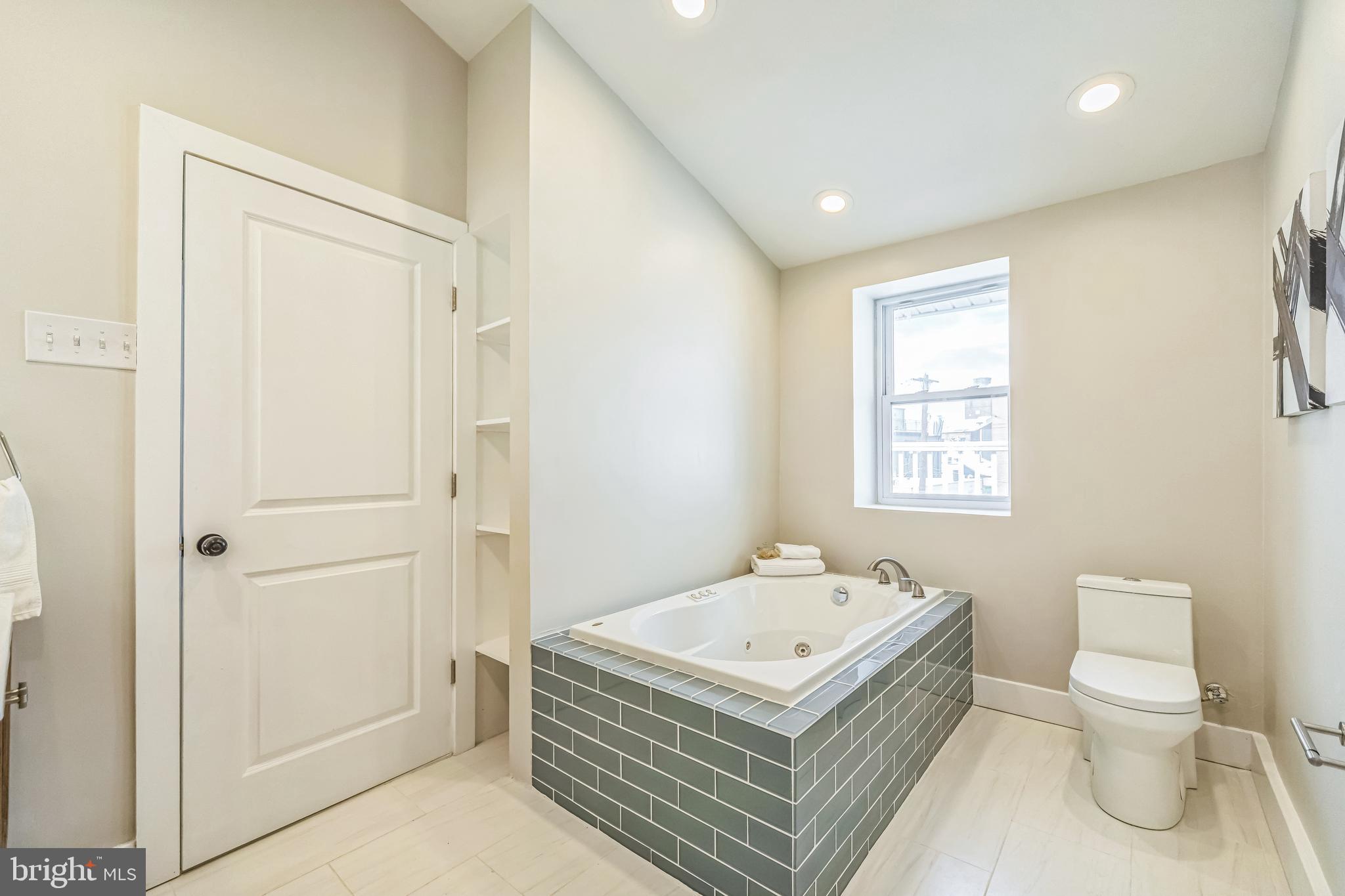 2123 East Norris Street Philadelphia, PA 19125 - Photo 27 of 40 a bathroom with a sink a toilet and shower
