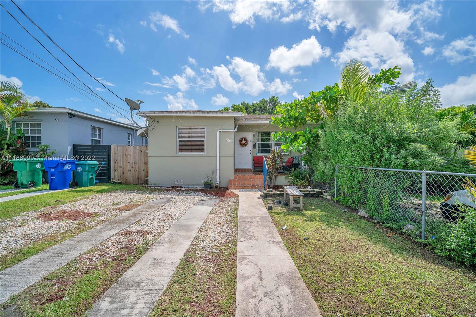 2800 Southwest 25th Street Miami, FL 33133 - Photo 2 of 19 a front view of a house with a yard and potted plants
