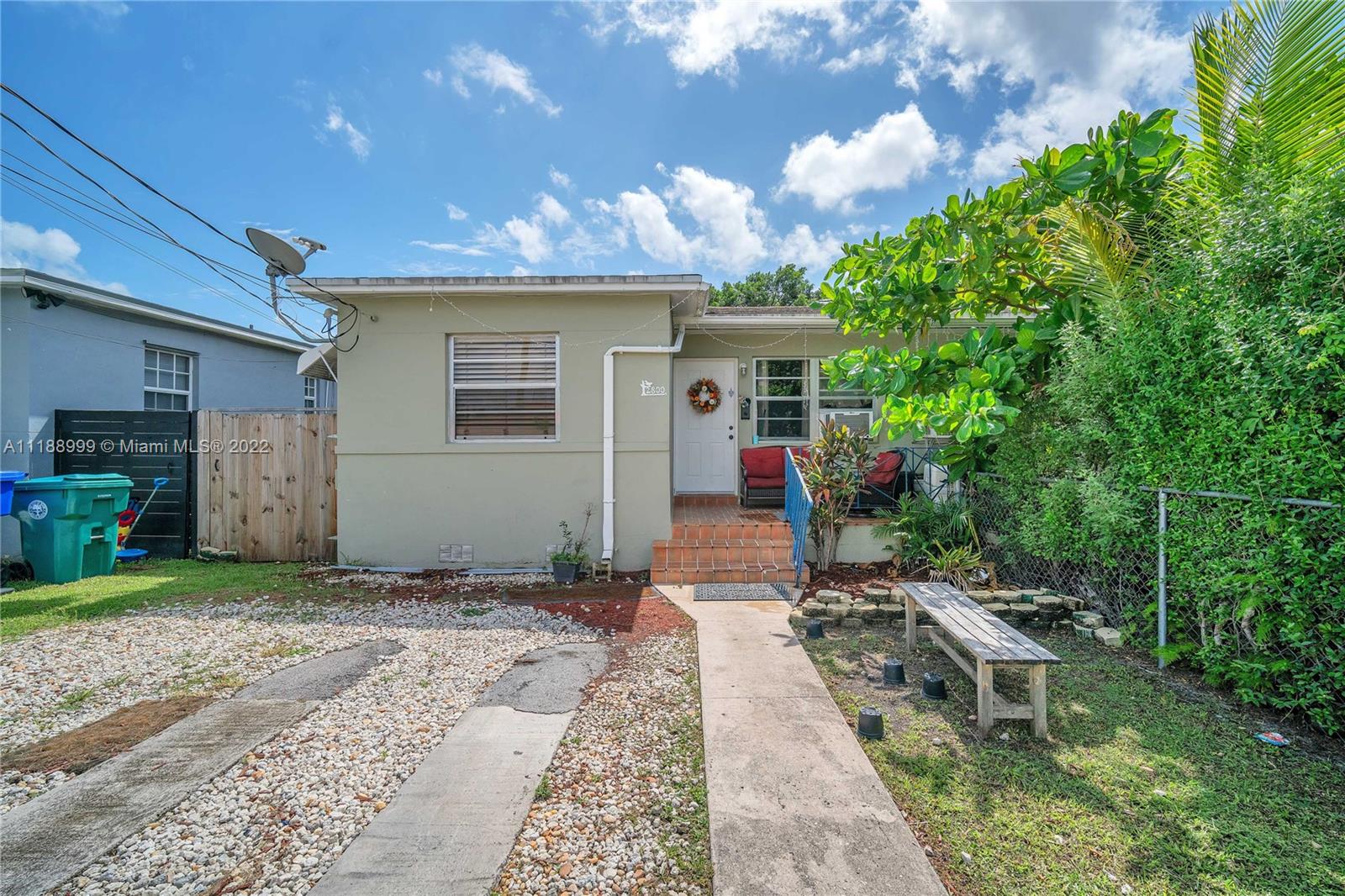 2800 Southwest 25th Street Miami, FL 33133 - Photo 3 of 19 a front view of a house with a yard and potted plants