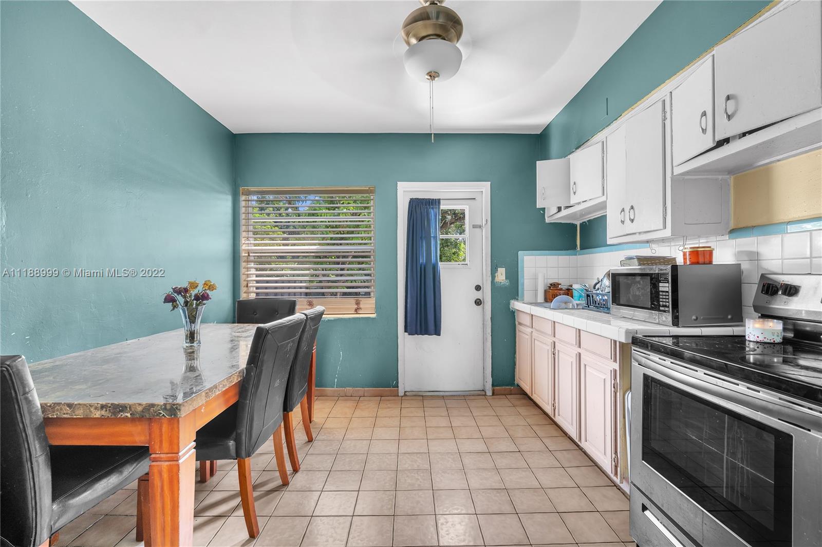 2800 Southwest 25th Street Miami, FL 33133 - Photo 7 of 19 a kitchen with stainless steel appliances granite countertop a stove top oven a sink dishwasher and a refrigerator
