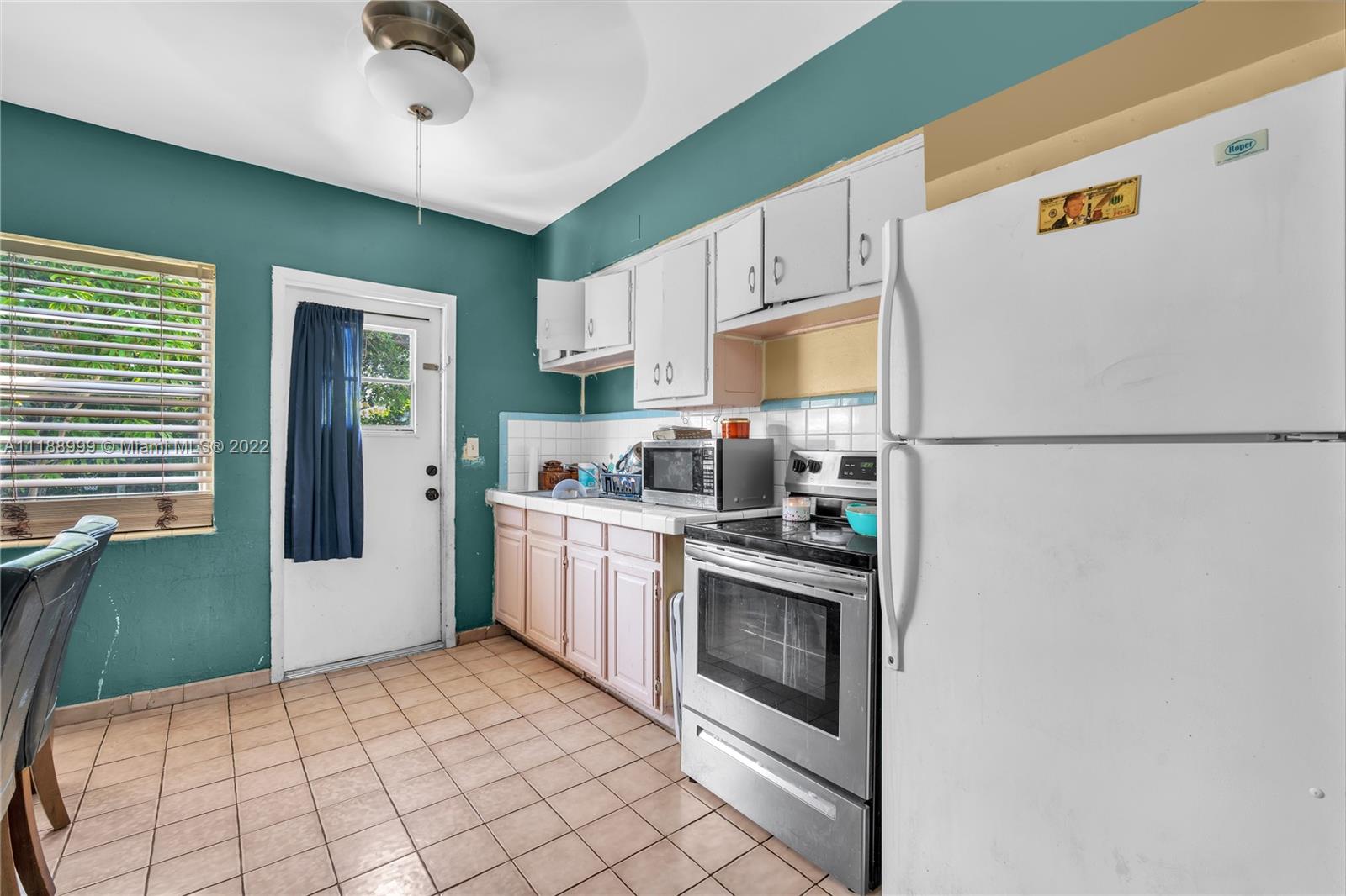 2800 Southwest 25th Street Miami, FL 33133 - Photo 8 of 19 a kitchen with stainless steel appliances a refrigerator sink and microwave