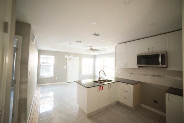 1310 West Harrison Avenue, Unit 2 Alton, TX 78573 - Photo 5 of 11 a room with a sink window and flat screen tv