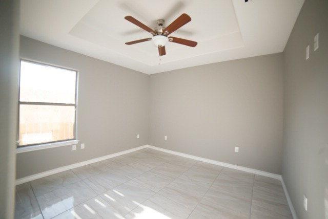 1310 West Harrison Avenue, Unit 2 Alton, TX 78573 - Photo 7 of 11 an empty room with ceiling fan and window