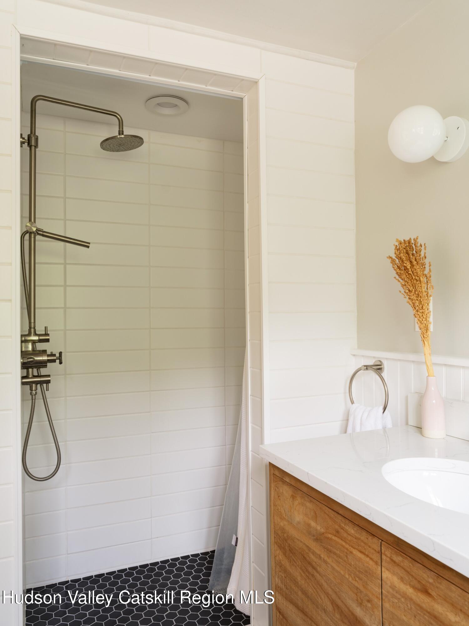 271 Texas Hill Road Hillsdale, NY 12521 - Photo 13 of 29 a bathroom with a granite countertop sink a mirror and shower