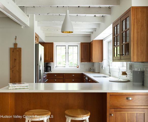 a kitchen with a sink cabinets and window