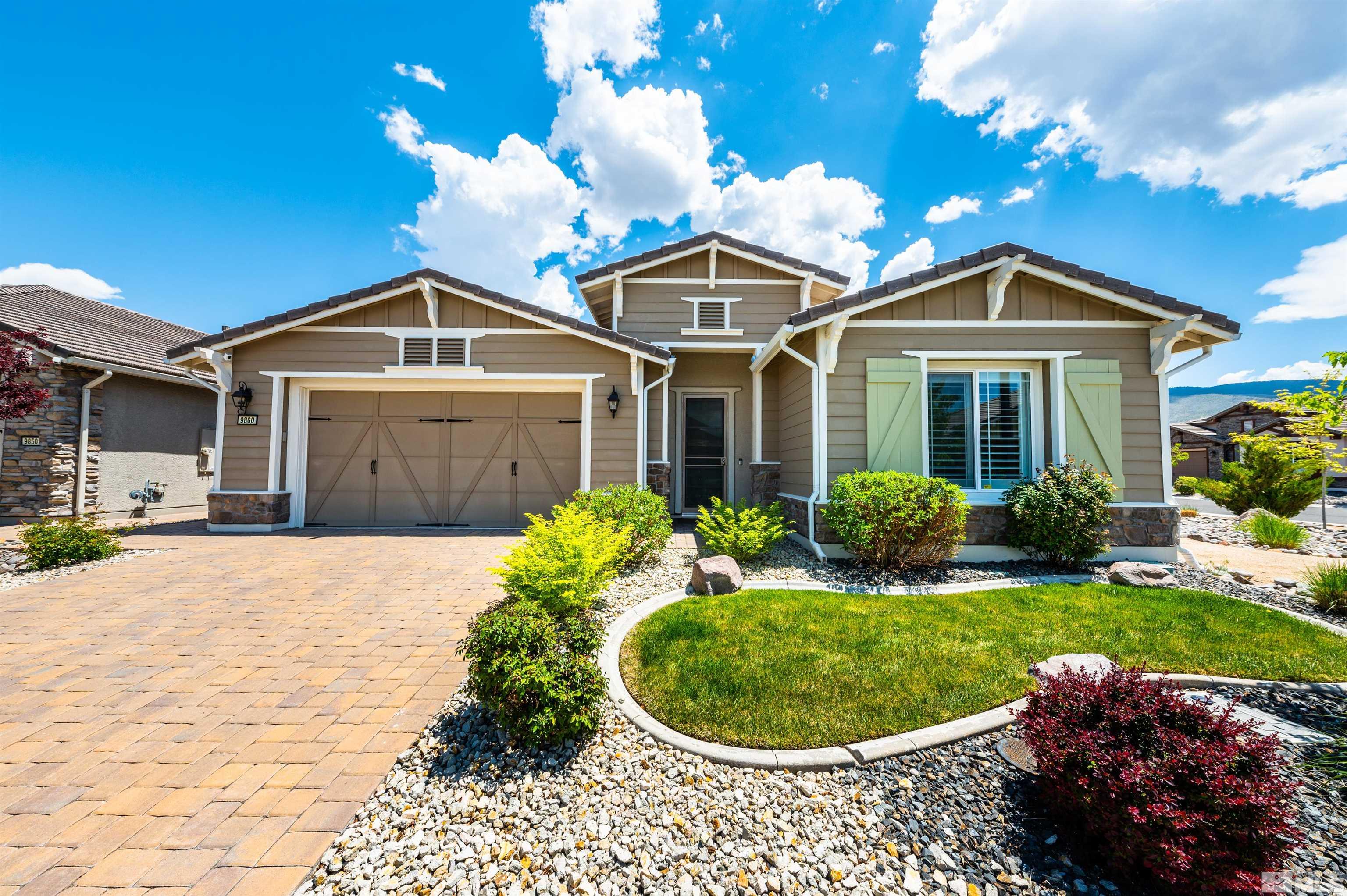 9860 Nahar Lane Reno, NV 89521 - Photo 1 of 40 a front view of a house with a garden and porch