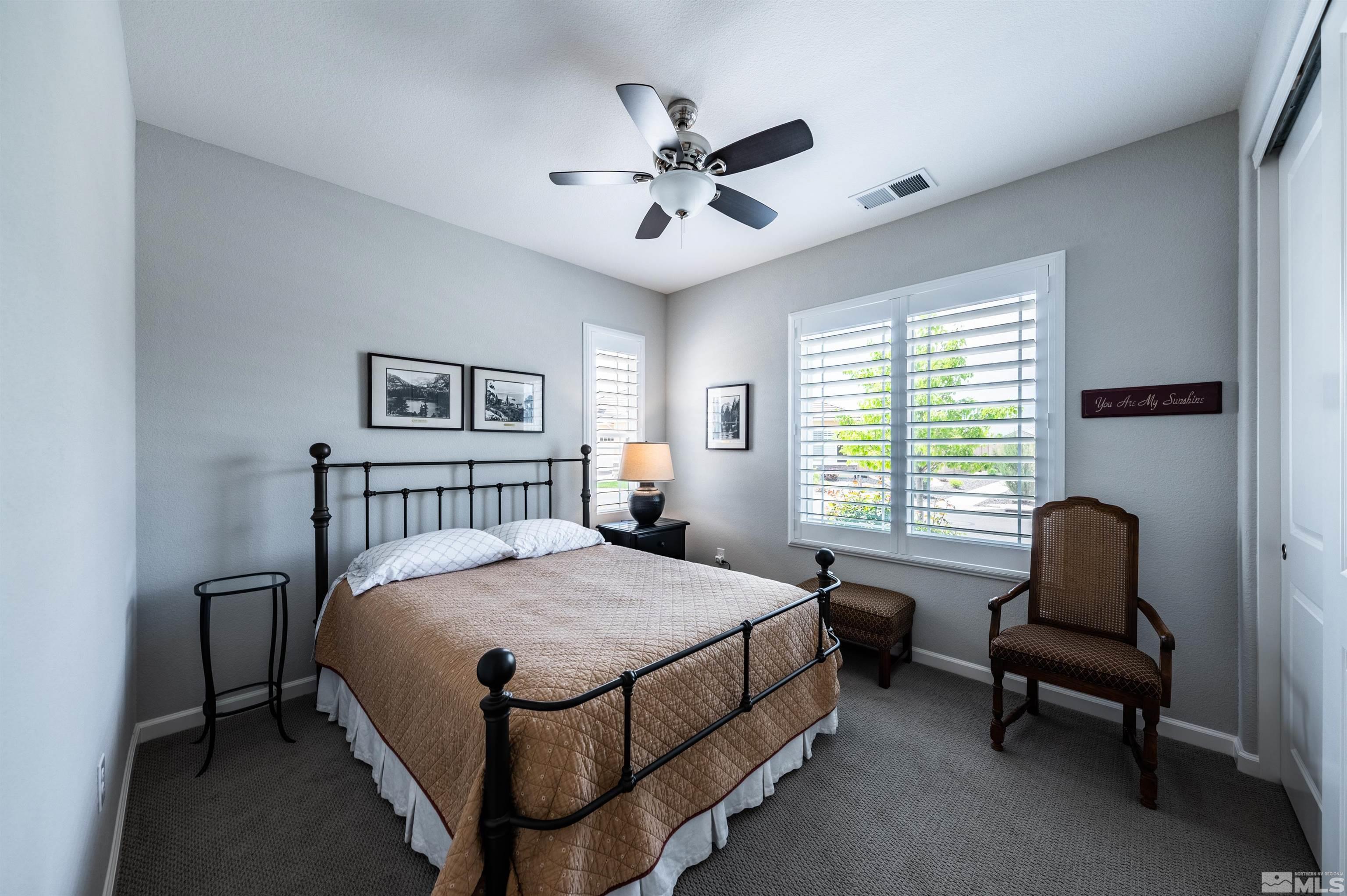 9860 Nahar Lane Reno, NV 89521 - Photo 20 of 40 a bedroom with a bed and a chair
