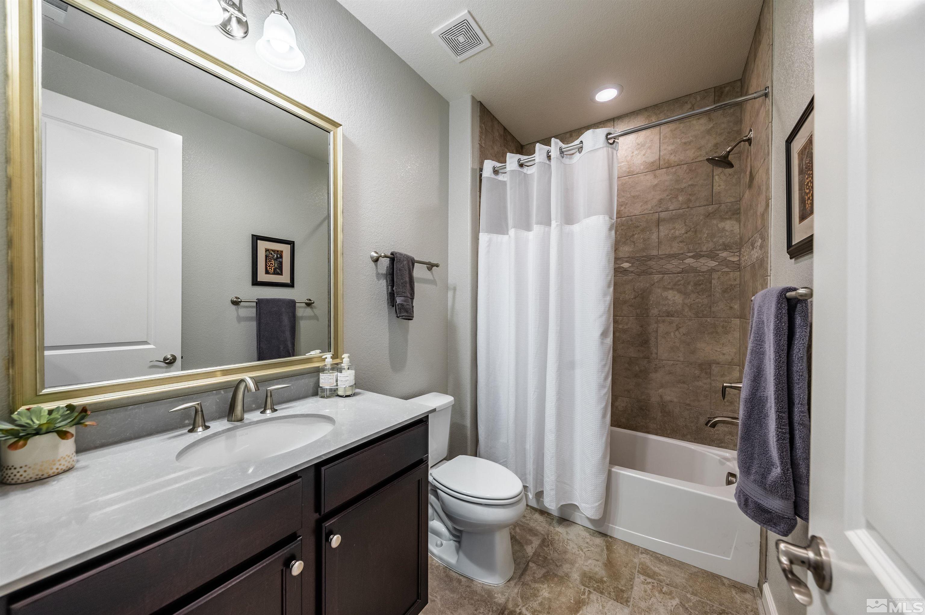 9860 Nahar Lane Reno, NV 89521 - Photo 21 of 40 a bathroom with a granite countertop sink toilet and shower
