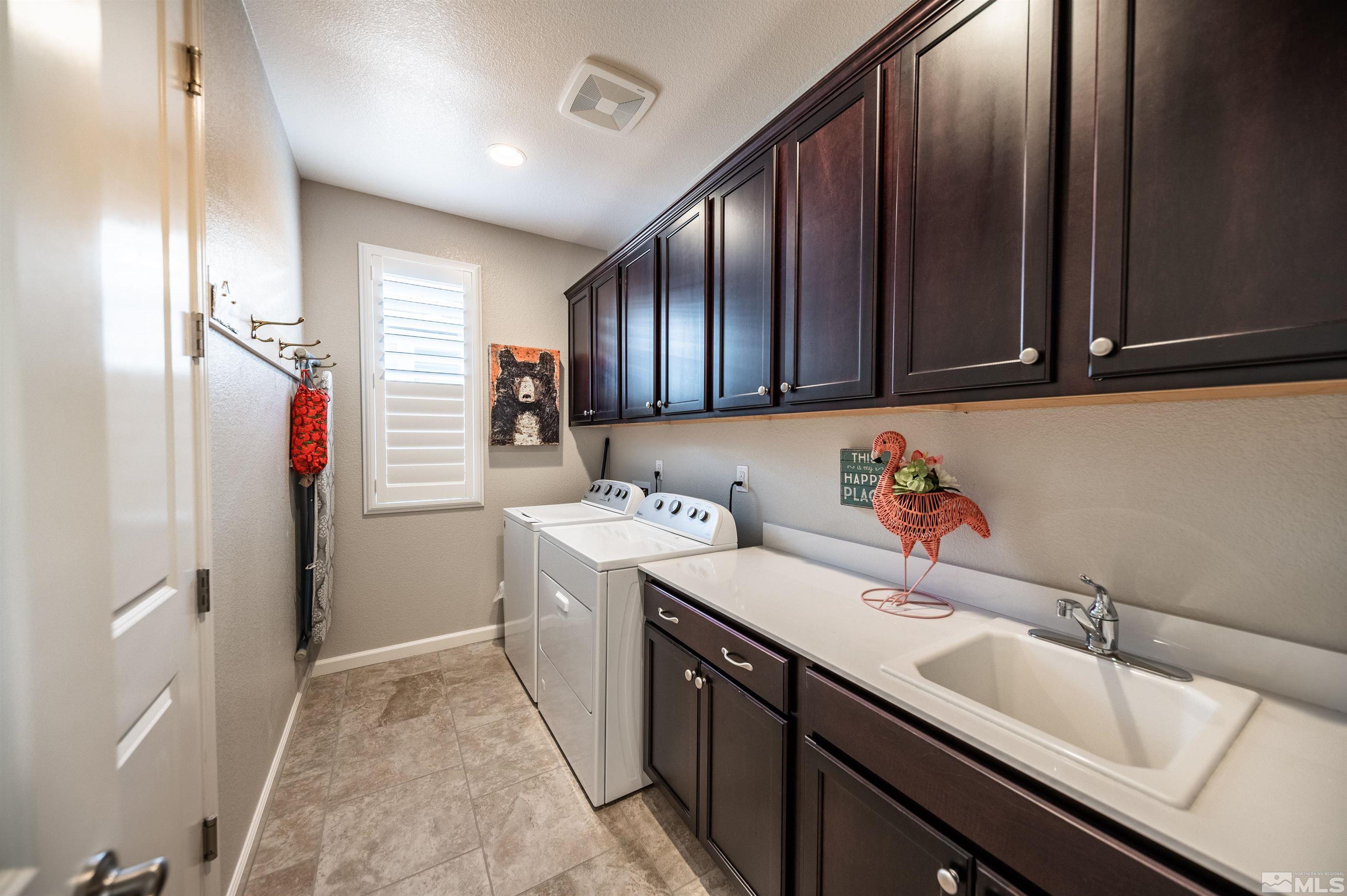 9860 Nahar Lane Reno, NV 89521 - Photo 22 of 40 a kitchen with a sink and a refrigerator