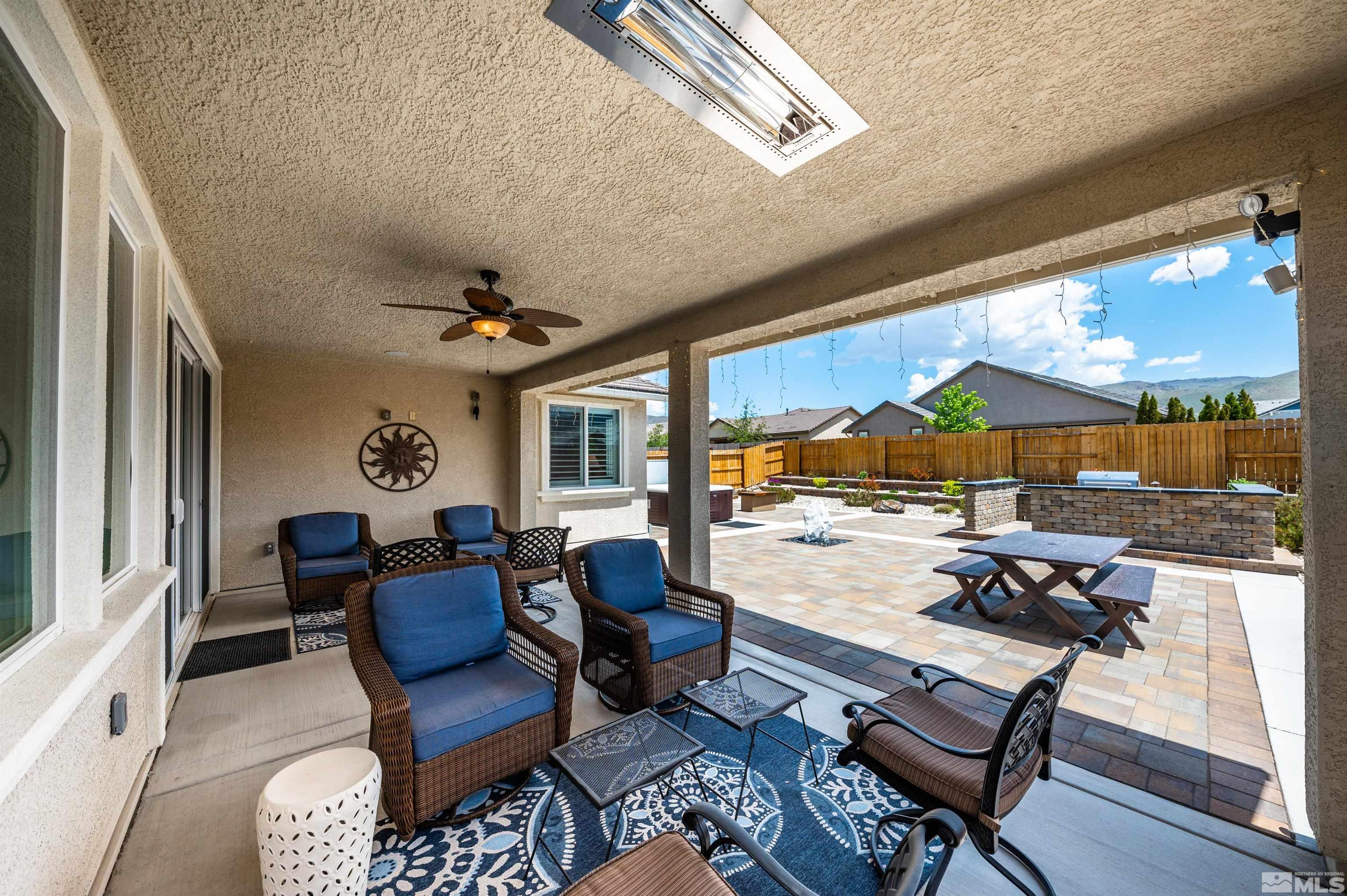 9860 Nahar Lane Reno, NV 89521 - Photo 25 of 40 a living room with furniture and a floor to ceiling window