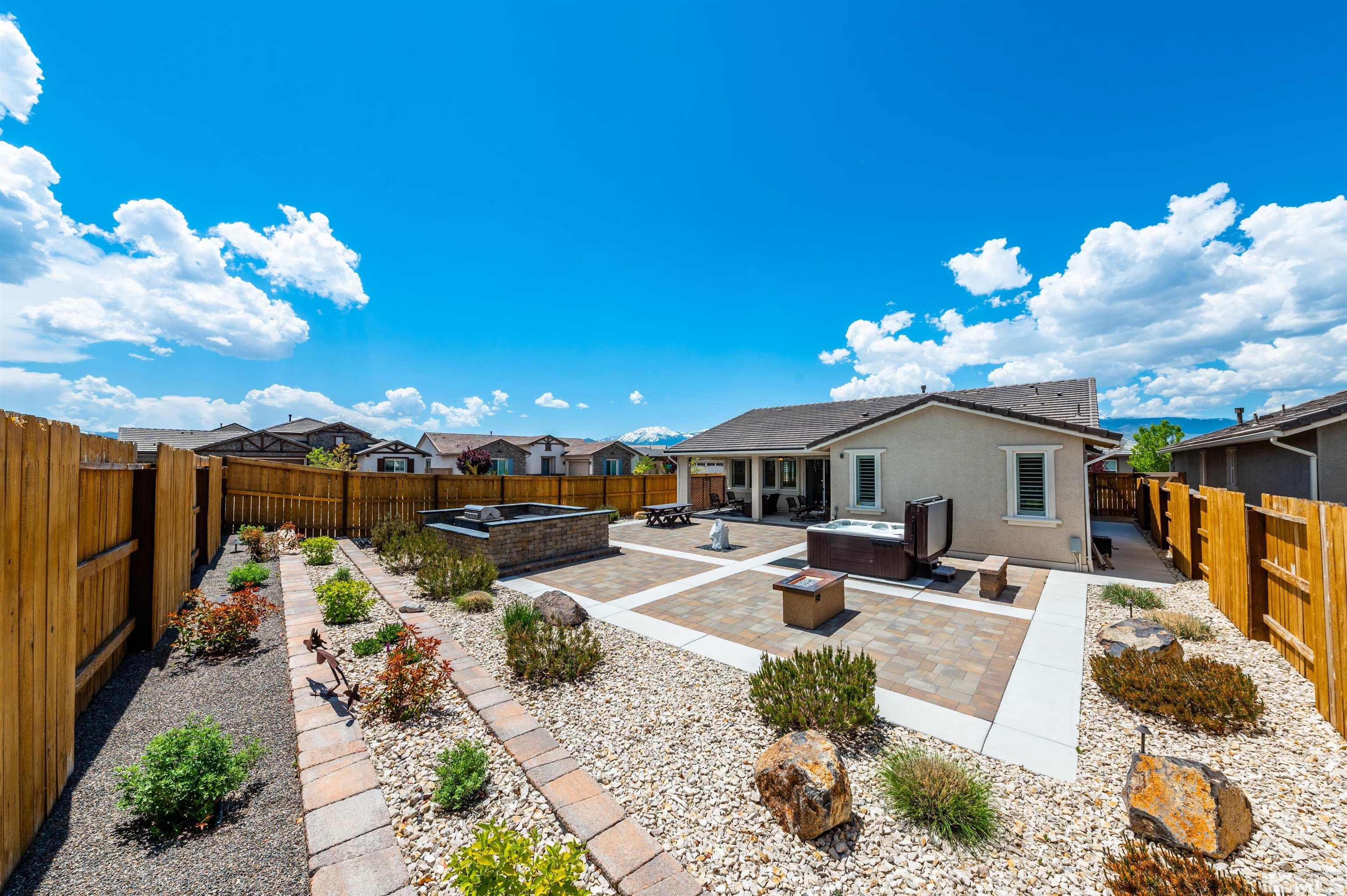 9860 Nahar Lane Reno, NV 89521 - Photo 30 of 40 a view of a house with backyard sitting area and swimming pool