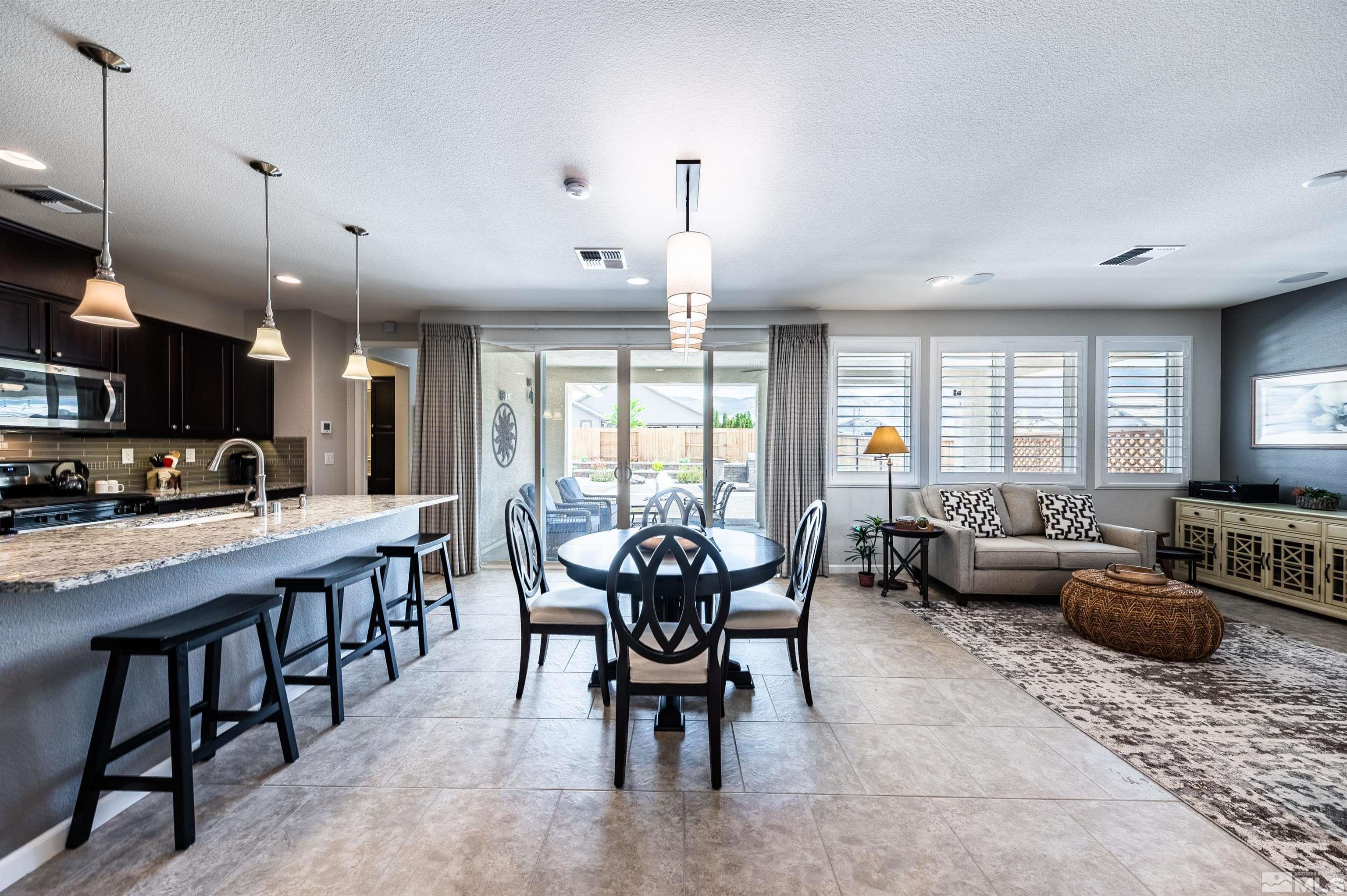 9860 Nahar Lane Reno, NV 89521 - Photo 6 of 40 a view of a dining room with furniture window and wooden floor