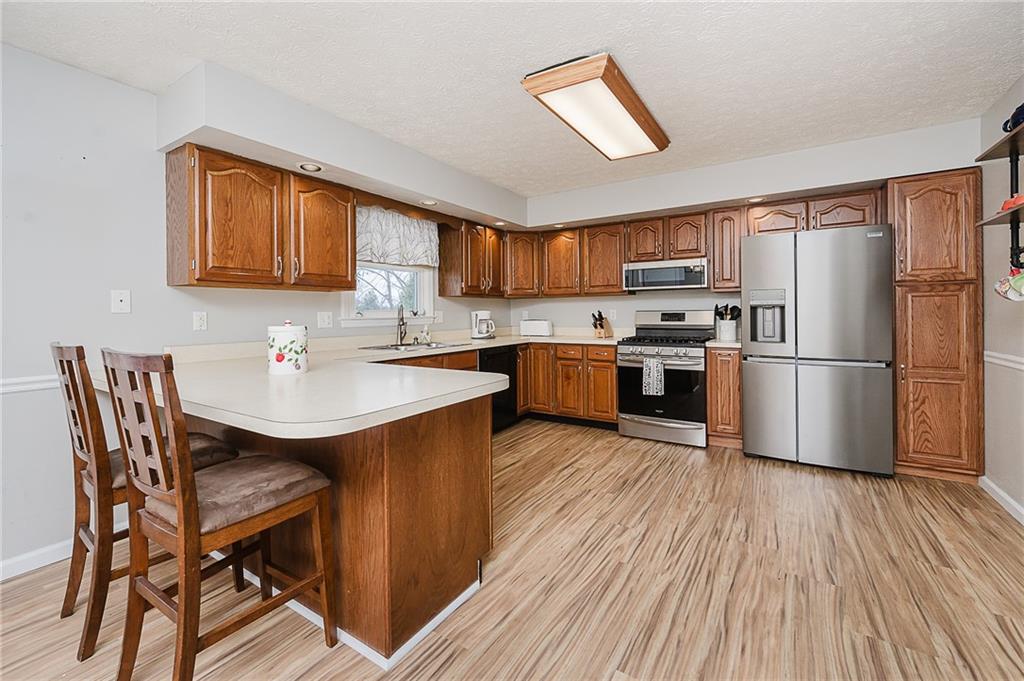 979 Barclay Road Indiana, PA 15701 - Photo 12 of 32 a kitchen with wooden floors and wooden cabinets
