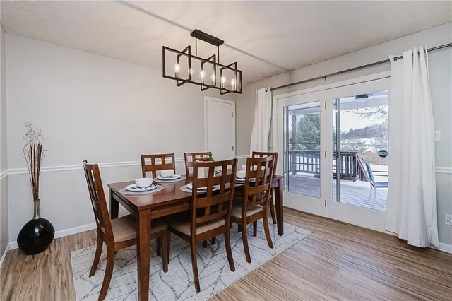 a view of a dining room with furniture wooden floor and chandelier
