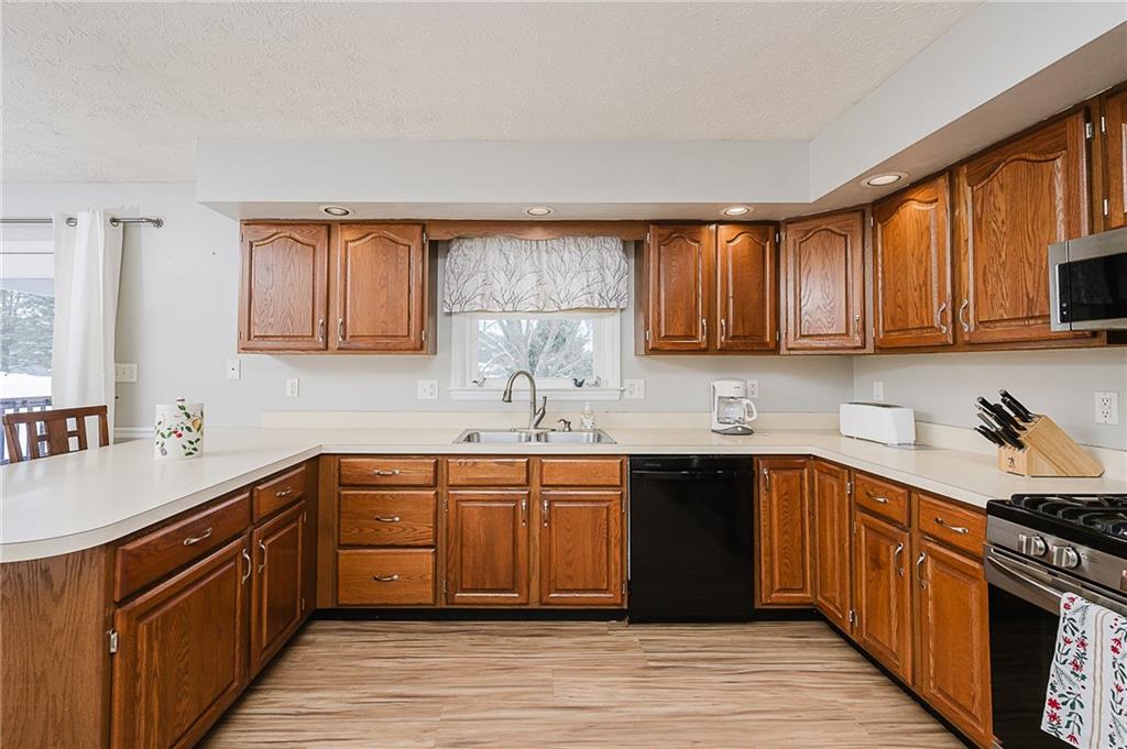 979 Barclay Road Indiana, PA 15701 - Photo 10 of 32 a kitchen with stainless steel appliances granite countertop wooden cabinets a sink dishwasher stove and refrigerator with wooden cabinets