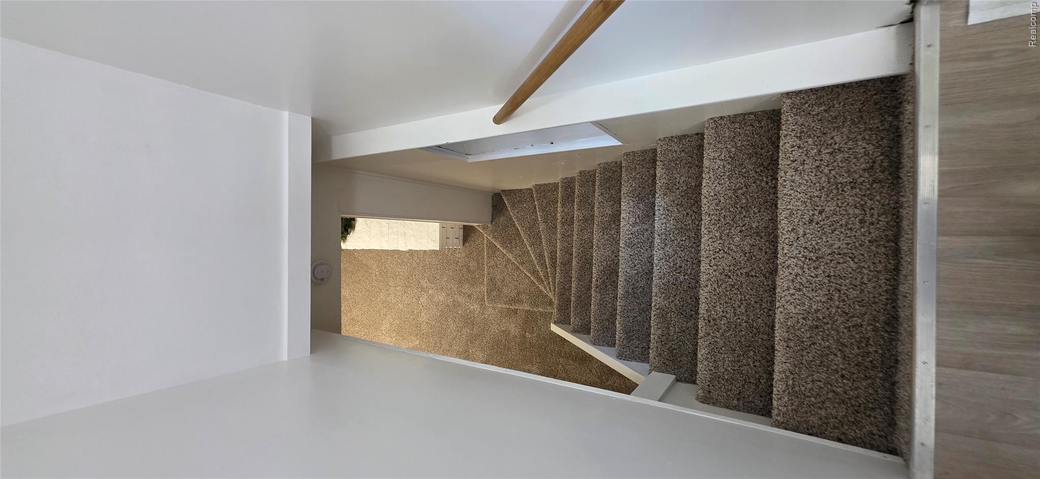4363 West Dodge Road Clio, MI 48420 - Photo 33 of 52 Carpeted staircase with light wood handrail and light-toned walls