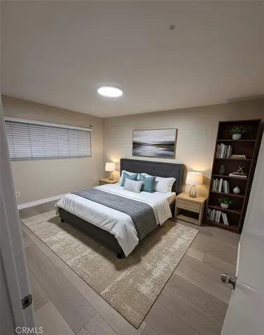 a bedroom with a bed and a view of living room