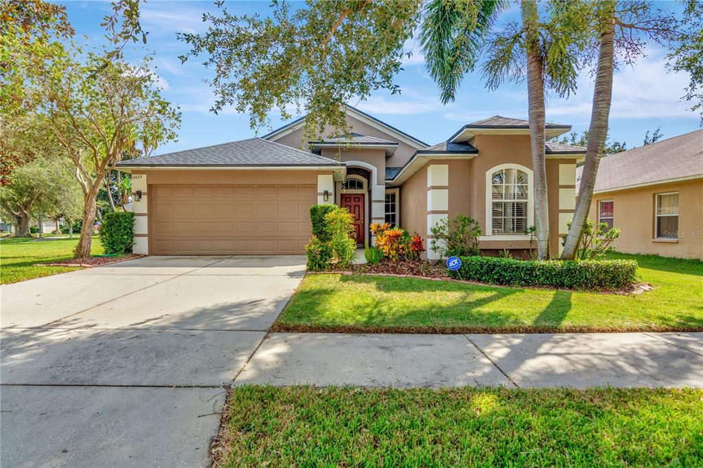 a front view of house with yard and green space