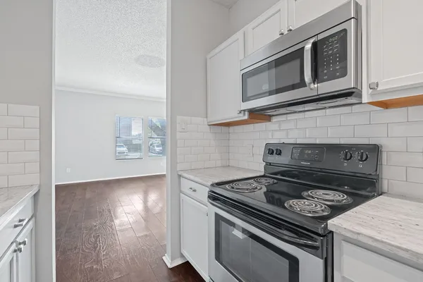 a stove top oven sitting inside of a kitchen