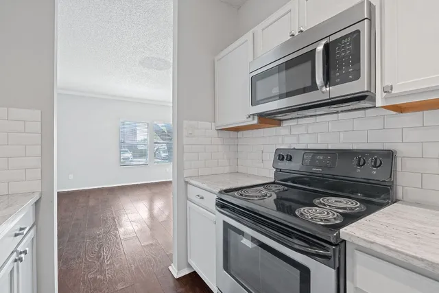 a stove top oven sitting inside of a kitchen