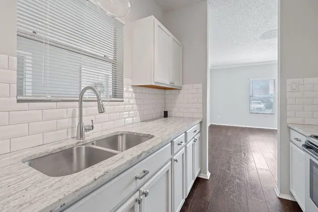 a kitchen with a sink and a hard wood floor