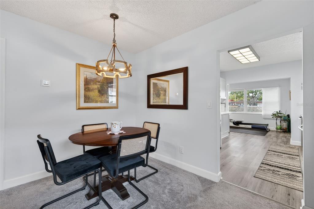 3740 58th Street North, Unit 110 St. Petersburg, FL 33710 - Photo 11 of 27 a dining room with furniture and window