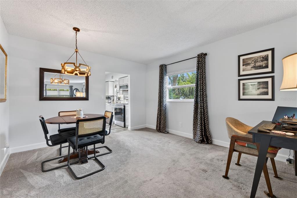 3740 58th Street North, Unit 110 St. Petersburg, FL 33710 - Photo 12 of 27 a work room with furniture and windows