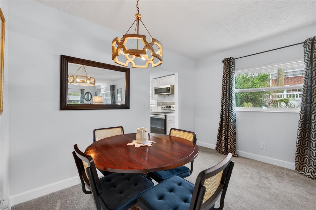 3740 58th Street North, Unit 110 St. Petersburg, FL 33710 - Photo 13 of 27 a dining room with furniture and window