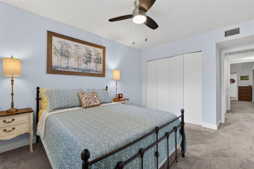 3740 58th Street North, Unit 110 St. Petersburg, FL 33710 - Photo 20 of 27 a bedroom with a bed and a chandelier