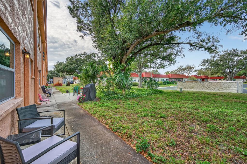 3740 58th Street North, Unit 110 St. Petersburg, FL 33710 - Photo 25 of 27 a view of yard with seating area and trees around