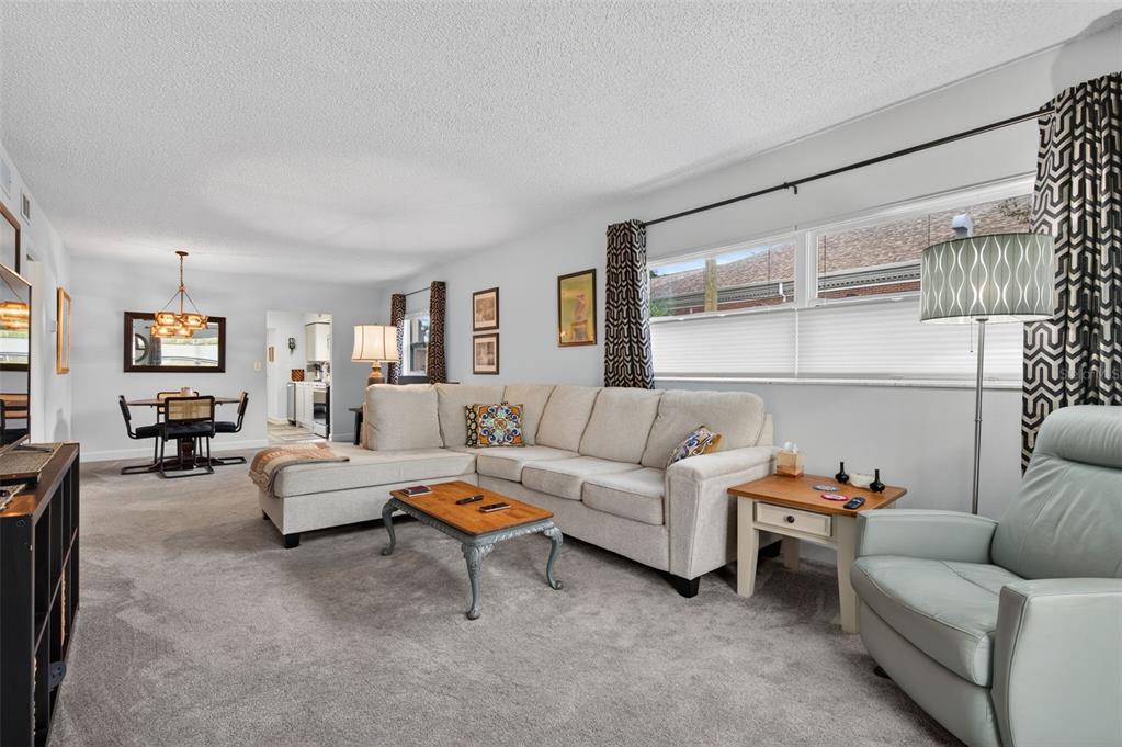 3740 58th Street North, Unit 110 St. Petersburg, FL 33710 - Photo 3 of 27 a living room with furniture and a large window