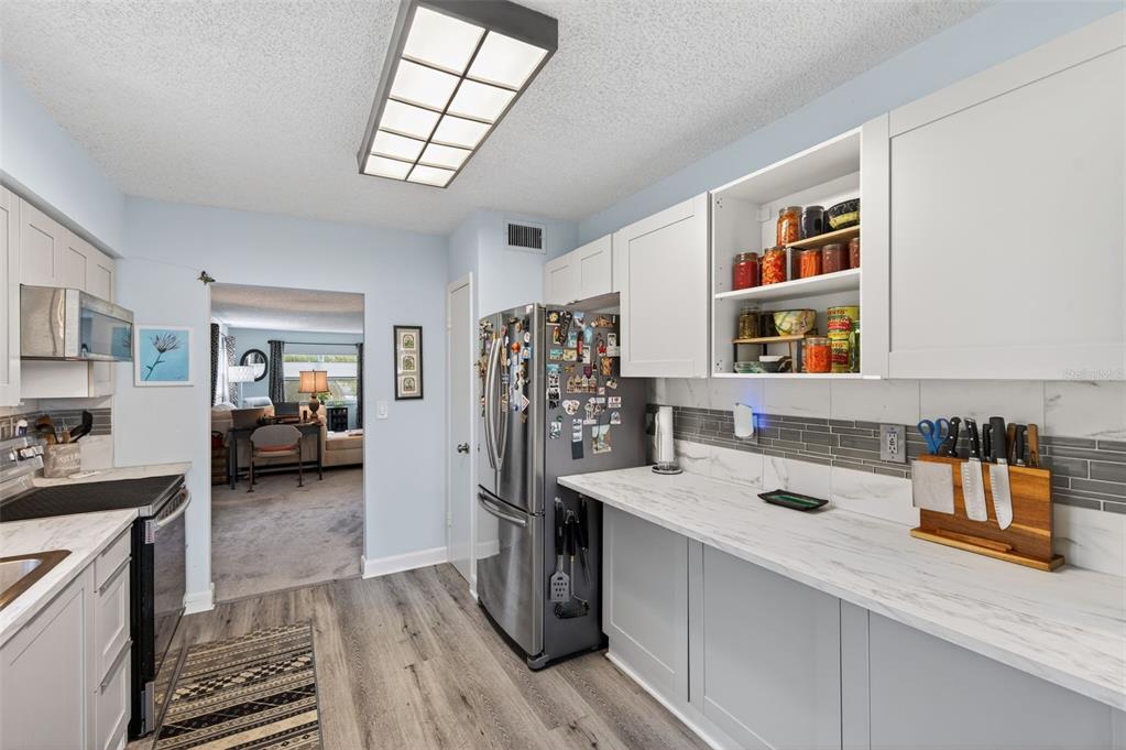 3740 58th Street North, Unit 110 St. Petersburg, FL 33710 - Photo 5 of 27 a kitchen view with a sink stove and cabinets