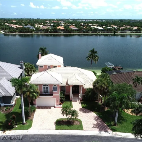 an aerial view of a house with a lake view