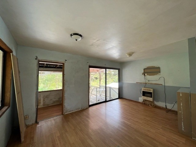 11-3715 Old Volcano Road Volcano, HI 96785 - Photo 4 of 14 an empty room with windows cabinet and wooden floor