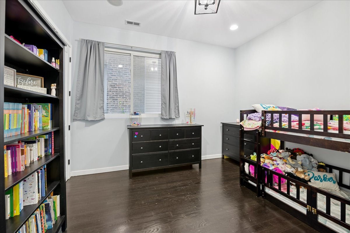 2019 North Whipple Street, Unit 1 Chicago, IL 60647 - Photo 16 of 33 a room with lots of books and a baby crib