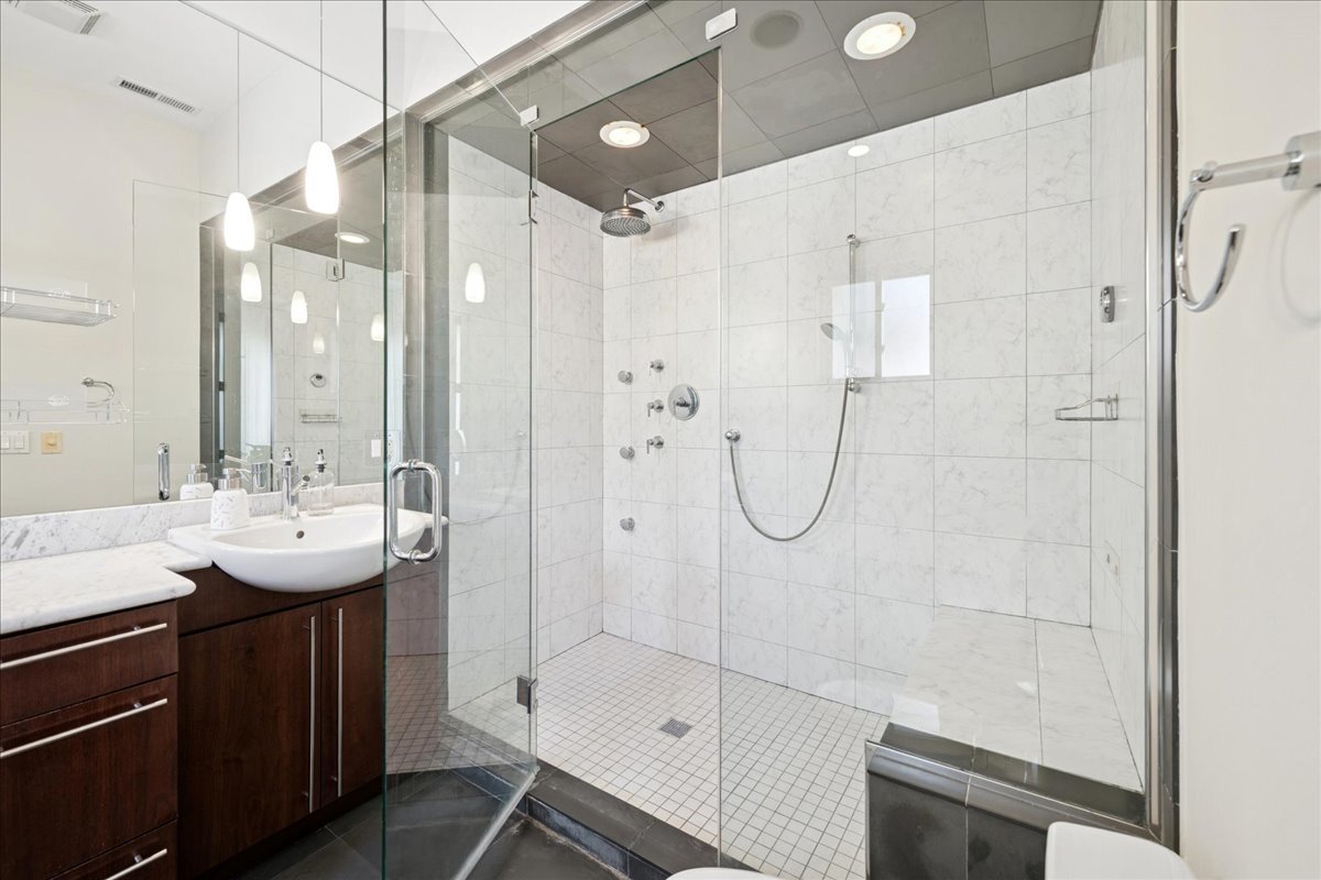 2019 North Whipple Street, Unit 1 Chicago, IL 60647 - Photo 22 of 33 a bathroom with a shower sink and mirror