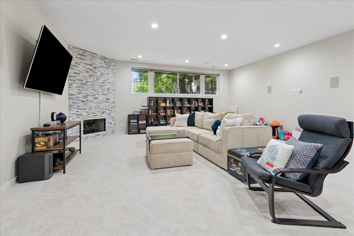 2019 North Whipple Street, Unit 1 Chicago, IL 60647 - Photo 24 of 33 a living room with fireplace furniture and a flat screen tv