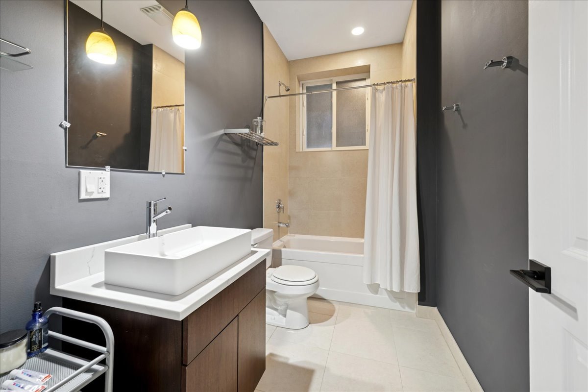 2019 North Whipple Street, Unit 1 Chicago, IL 60647 - Photo 28 of 33 a bathroom with a sink a toilet and a mirror