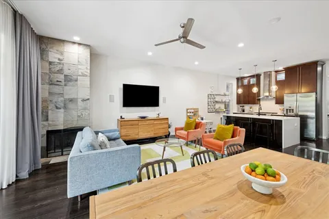 a large kitchen with a table and chairs