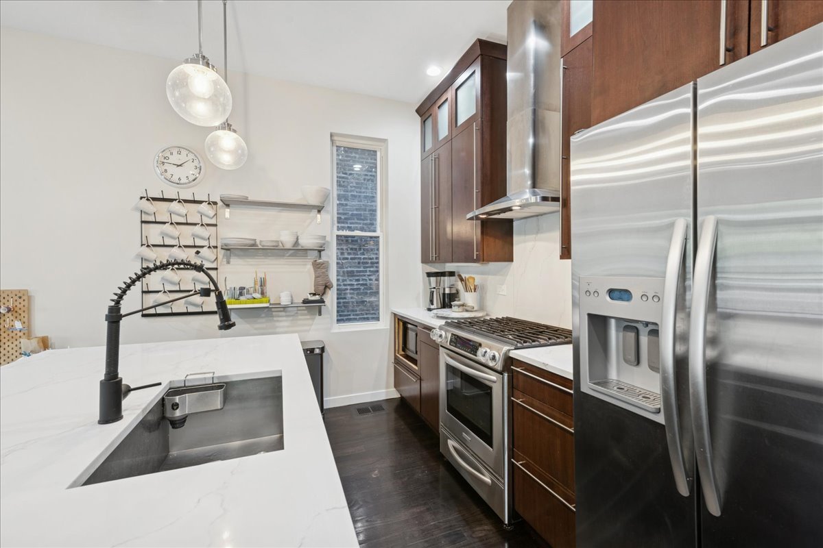 2019 North Whipple Street, Unit 1 Chicago, IL 60647 - Photo 10 of 33 a kitchen with stainless steel appliances granite countertop a sink a stove and a refrigerator