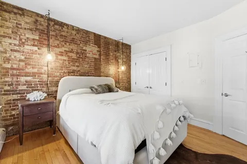 a bedroom with a bed and dresser